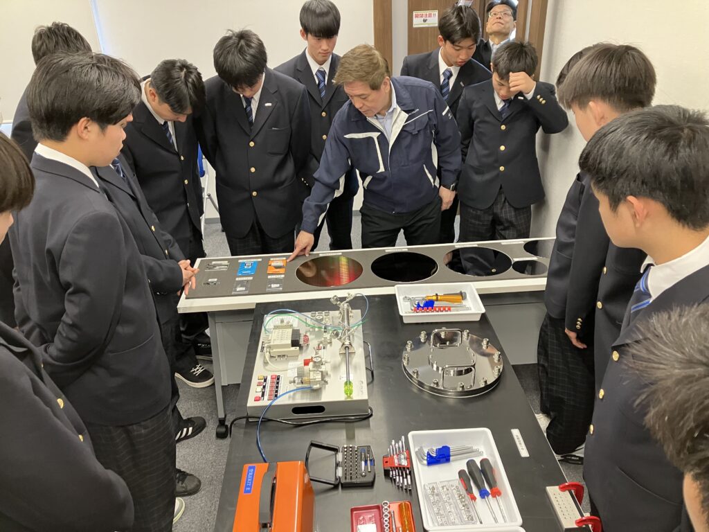半導体の素材が並ぶ教室で話を聞く開新高校の生徒たち